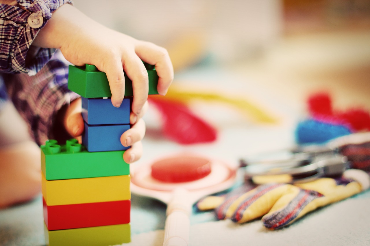 Un enfant qui empile des Lego dans une crèche