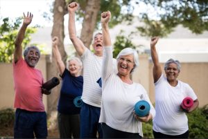 Des seniors avec des tapis de yoga roulés sous le bras